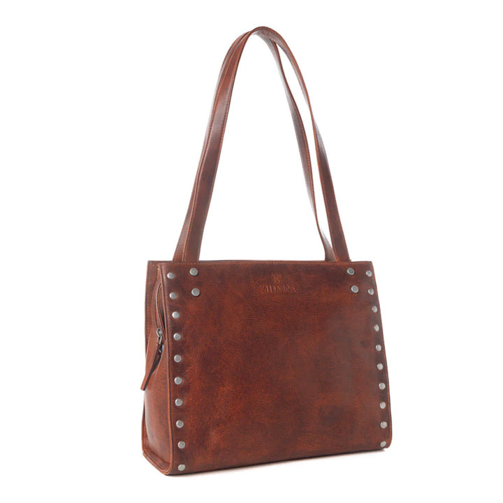 Brown leather handbag with studs on a white background