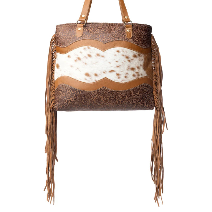 Brown leather handbag with cowhide and fringe on a white background