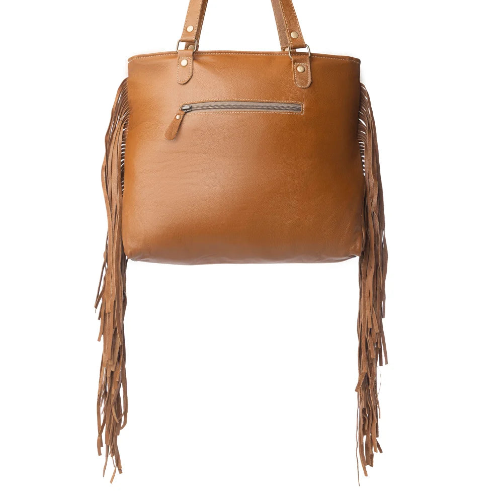 Brown leather handbag with fringe details on a white background
